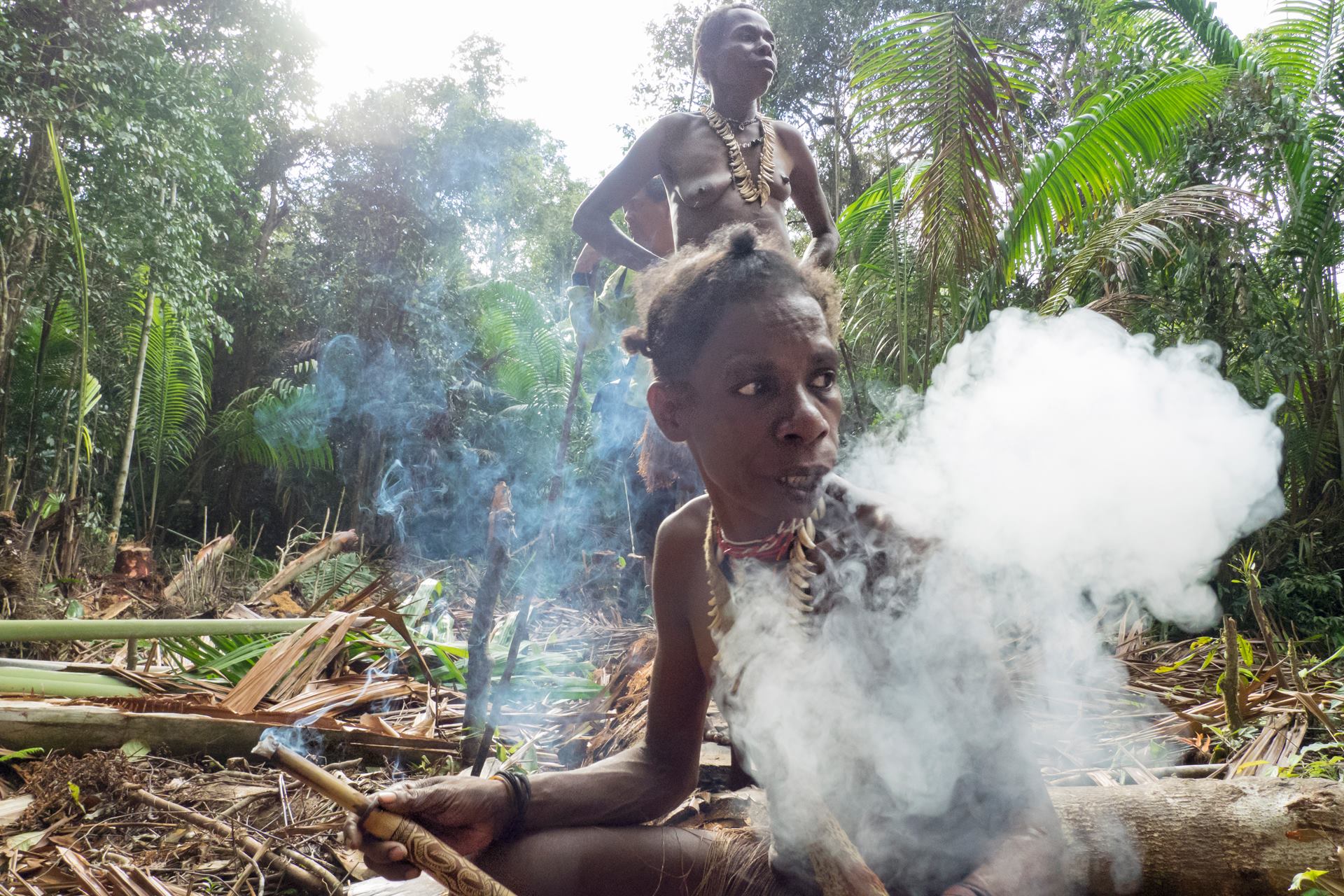 Korowai woman smoking traditional tobacco